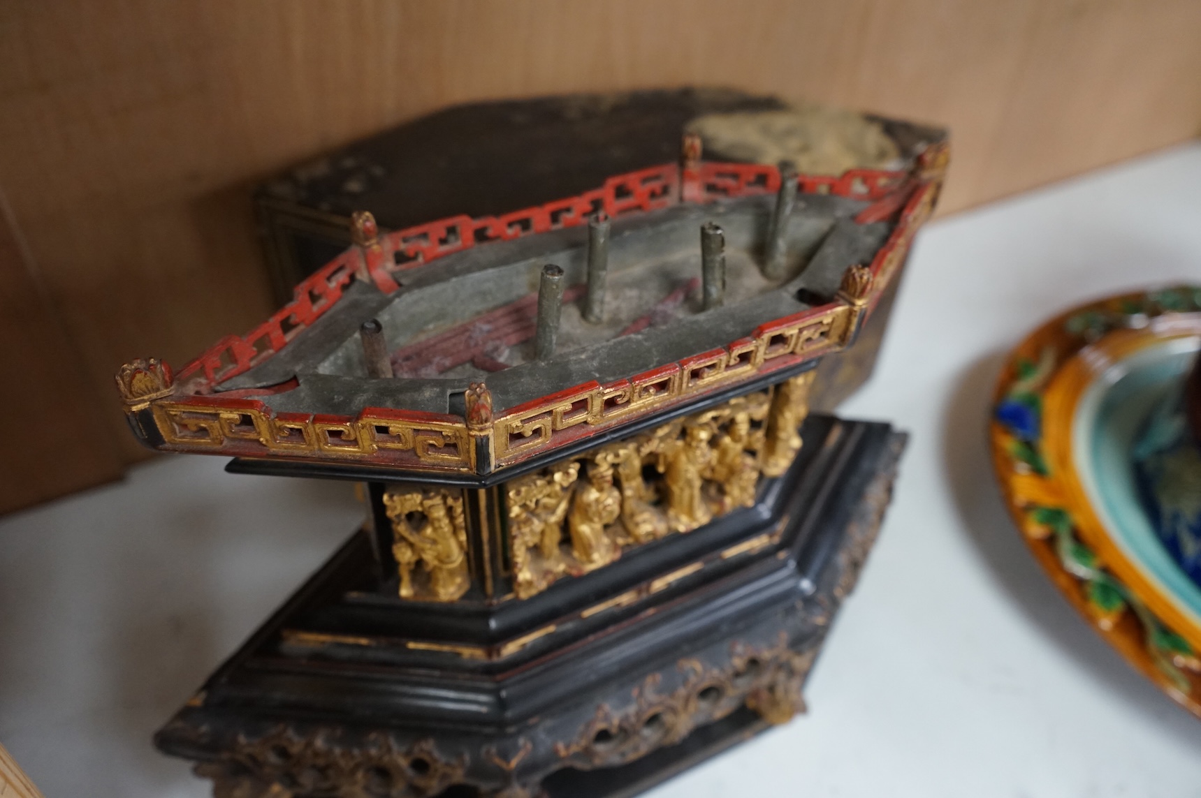 A Chinese lacquered and carved wood temple ornament, 26.5cm high, 32cm widest on base.